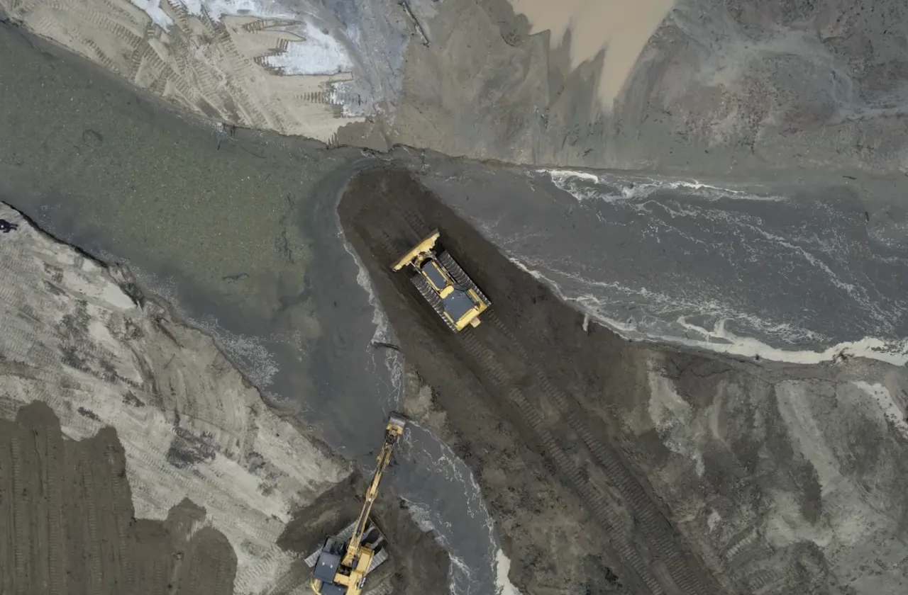 Drone image of Paradise Pond work with a yellow bulldozer and excavator moving silt