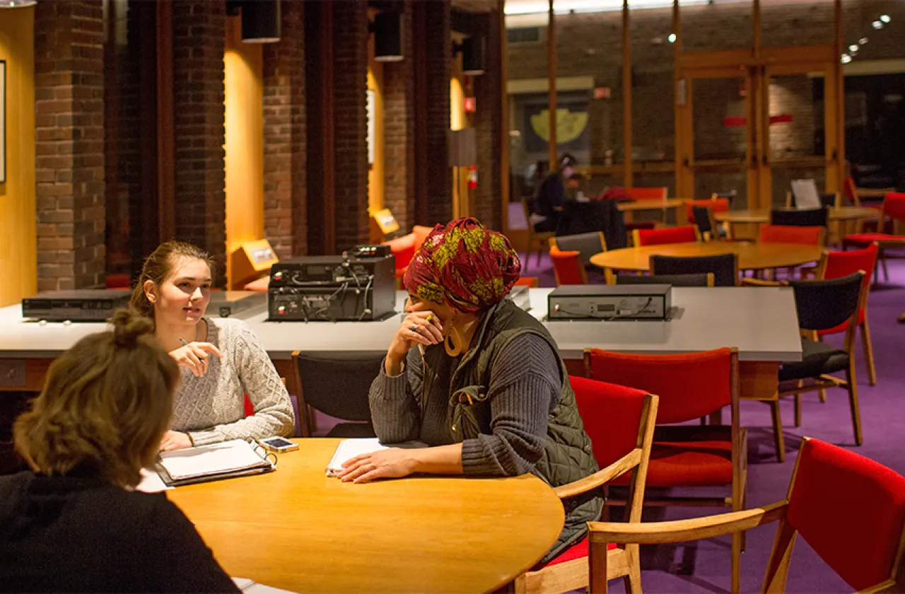 Interior of Josten Library with four students working at a table