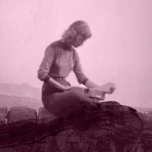 Sylvia Plath sitting on mountain edge