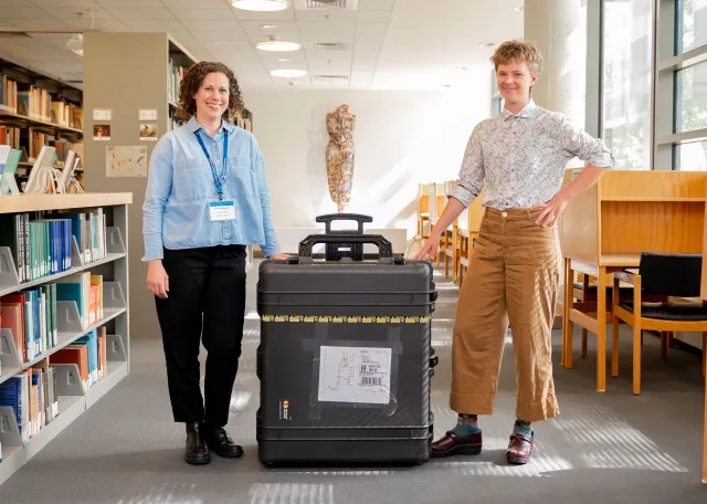 Visual Arts and Humanities Librarian Anna Helgeson and Hillyer Access Services Branch Coordinator Anna Morrissey stand with the shipping container housing The Sistine Chapel