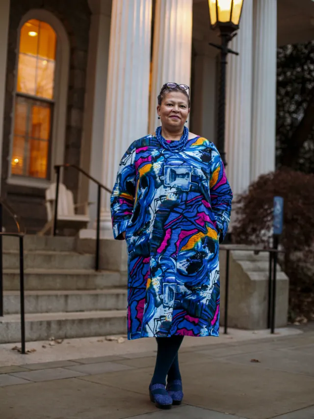 Sarah Willie-LeBreton with a slight smile in front of a Swarthmore building