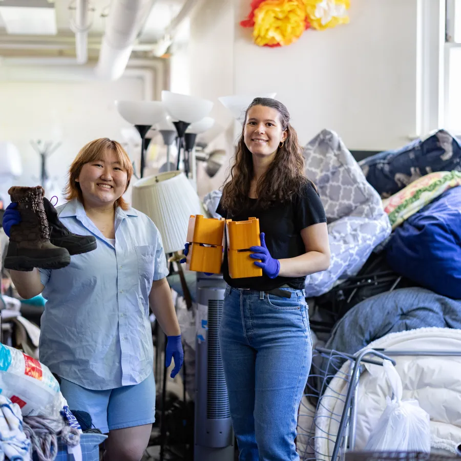 Jena Kim and Molly Neu sorting through items at SmithCycle in Scales House basement