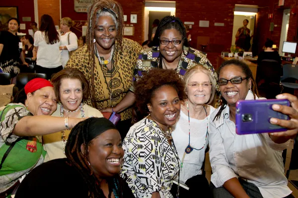 Gloria Steinem takes a selfie with a group of Gloria and Wilma School students