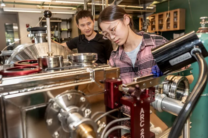 A student and a supervisor in a lab.