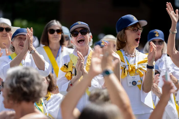 Smithies in blue baseball hats cheer during Reunion II