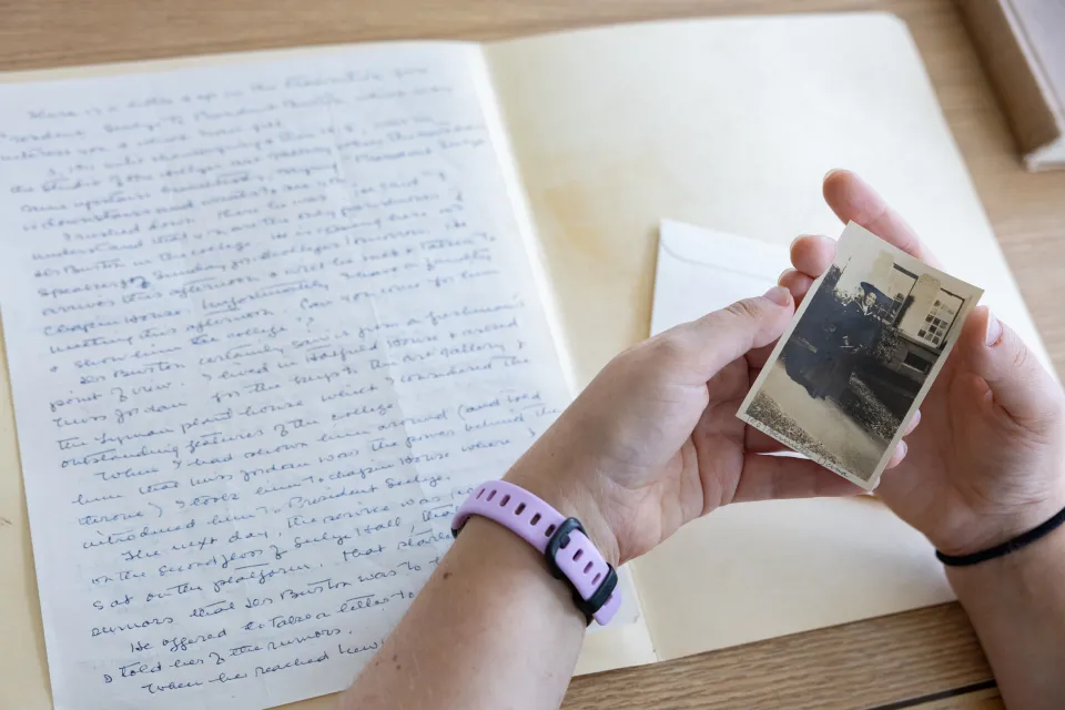 Kady Wilson's hands as she holds a black and white photo of her great-grandmother in Special Collections