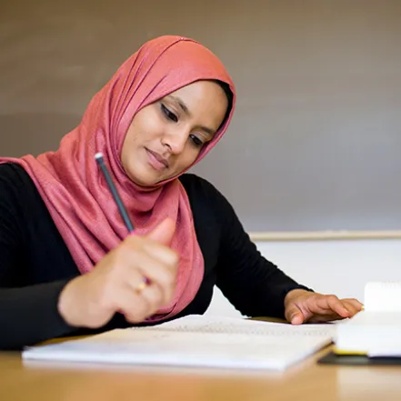 Young woman writing at a desk